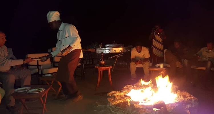 People sitting around a campfire at night