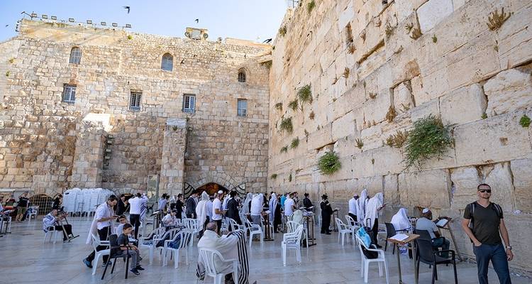 People praying and interacting at the Western Wall.