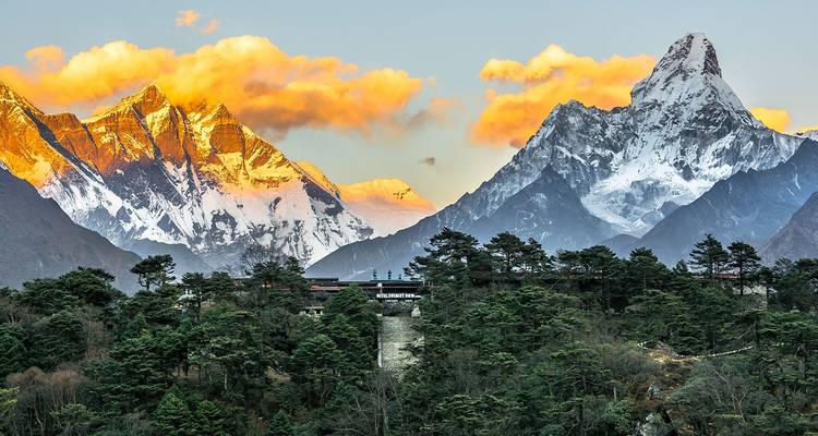 Majestic snow-capped mountains under a sunset sky.