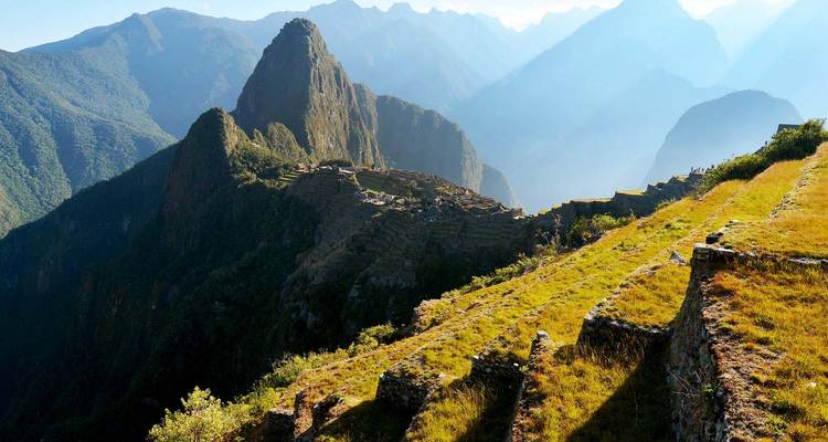 Vista panorámica de Machu Picchu y las montañas circundantes al amanecer.