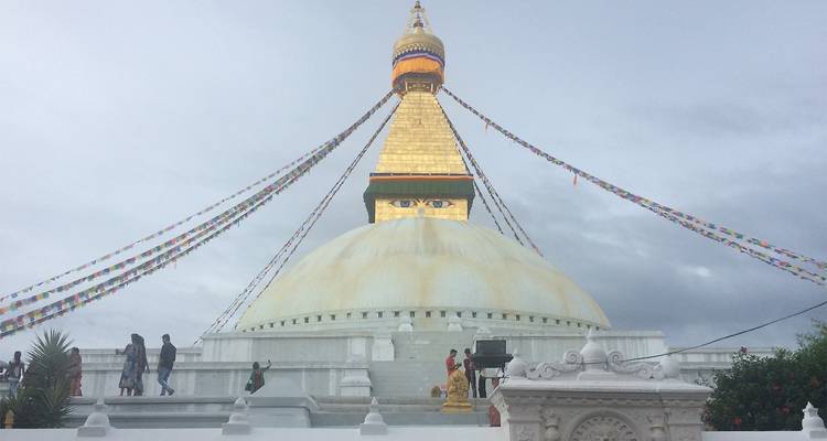 Large gold-domed stupa with prayer flags.