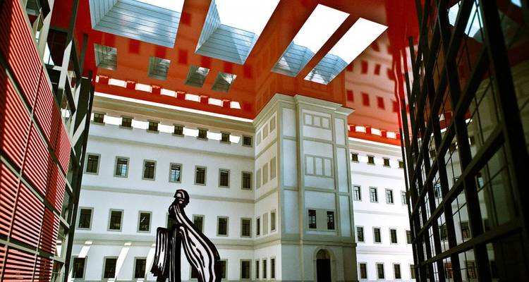 Interior courtyard with modern architecture featuring a large sculpture.