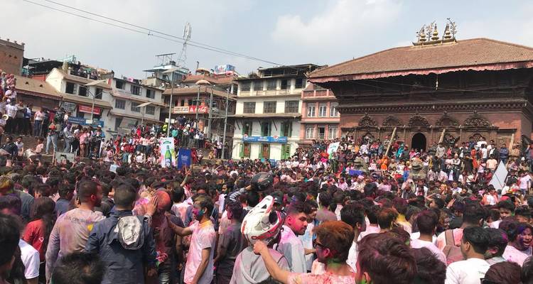 A large crowd celebrating in a historic city square.
