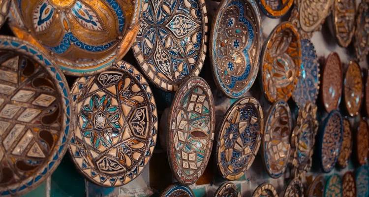 Colorful hand-painted plates on a wall.