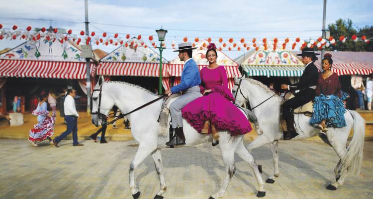 Des gens à cheval en tenue traditionnelle lors d'un festival.