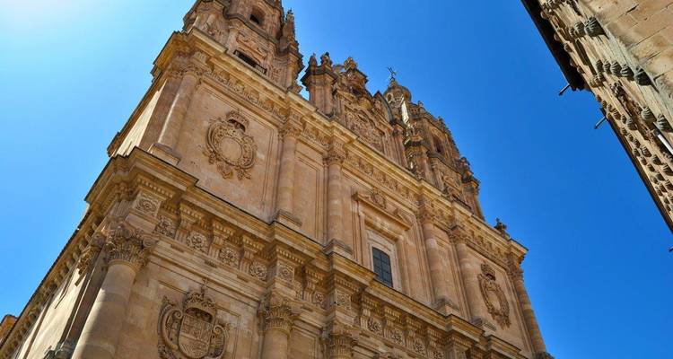 View of an ornate historical building with intricate carvings under a clear blue sky.