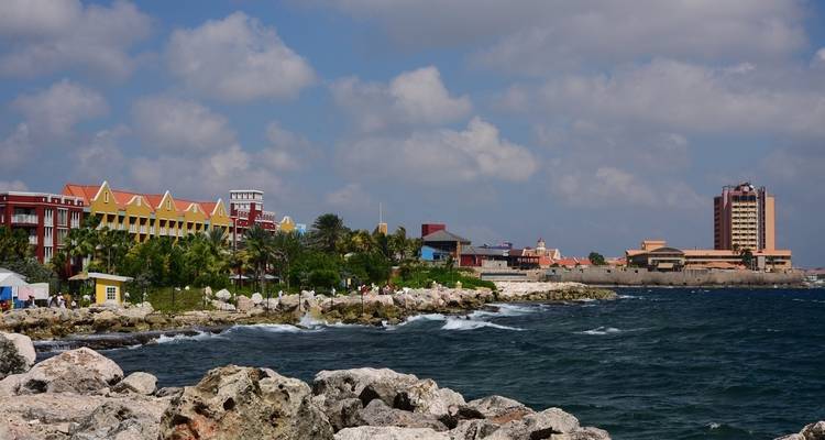 Coastal cityscape with colorful beachfront buildings.