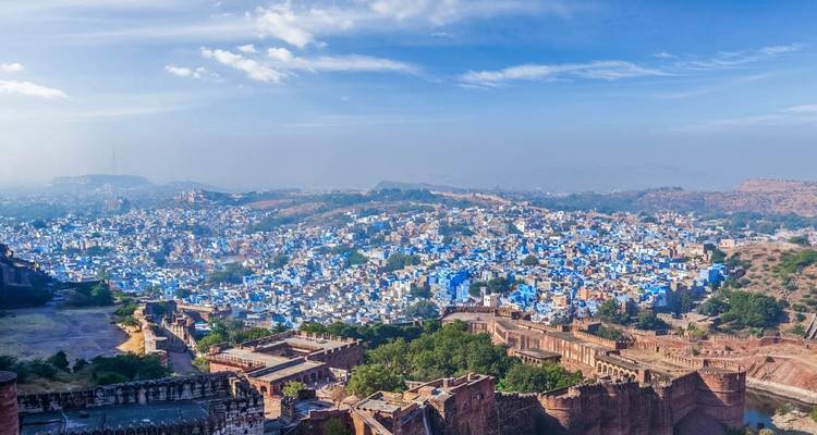 Aerial view of a city with blue-painted buildings.