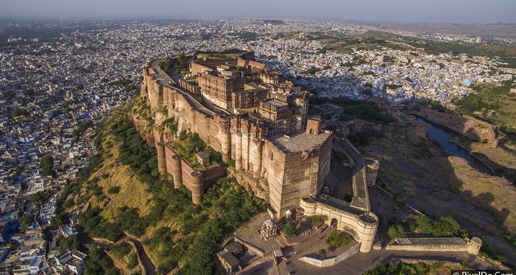 Aerial view of a large fort with city in the background.