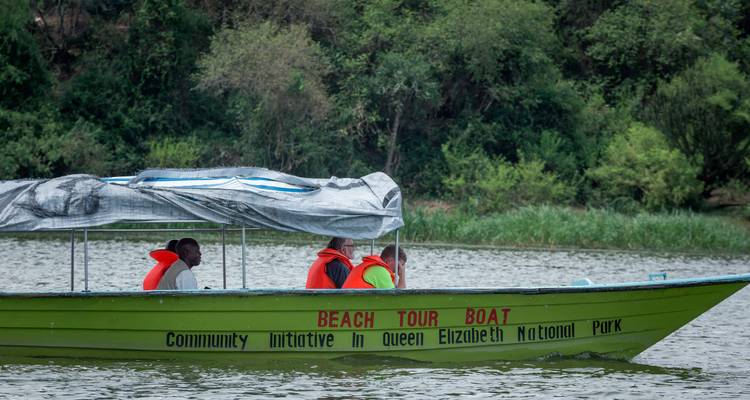 Boat tour with people wearing life jackets in a river.