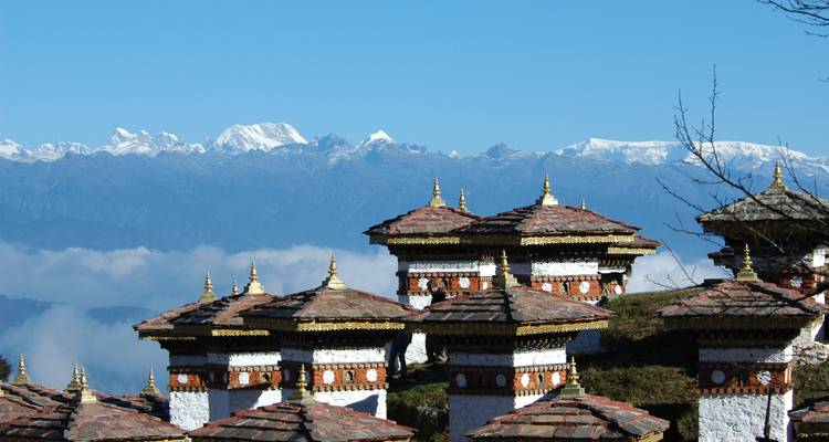 Schilderachtig uitzicht op traditionele Bhutanese stupa's met de Himalaya-bergen op de achtergrond.
