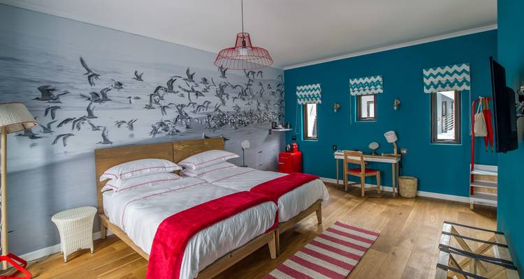 Stylish bedroom in a modern design with blue walls and photographic mural.