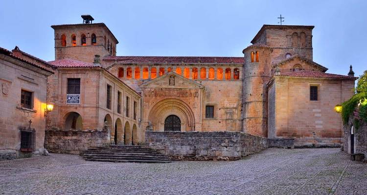 Stone monastery courtyard glowing in soft evening light, northern Spain
