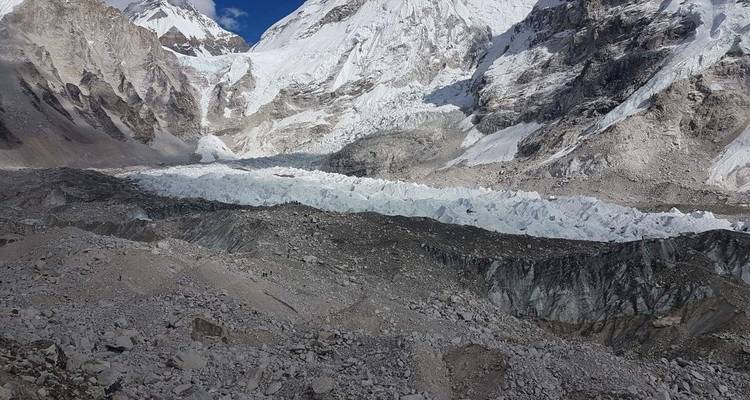 Crevasse with rocky terrain and snow cover.