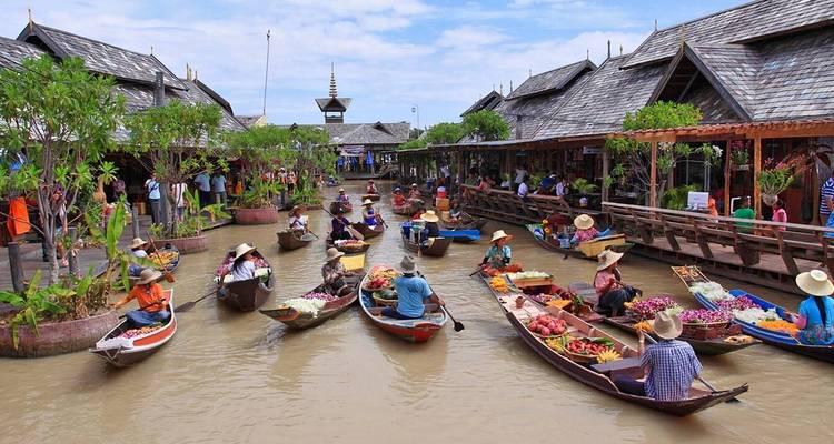 Colorful floating market with multiple boats on a canal.