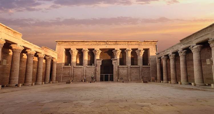Ancient temple with columns at sunset.
