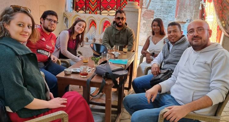 Group of people sitting at a table enjoying beverages.