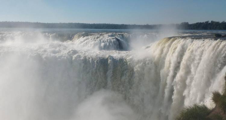 Vue des puissantes chutes d'Iguazu avec de la brume s'élevant de l'eau.