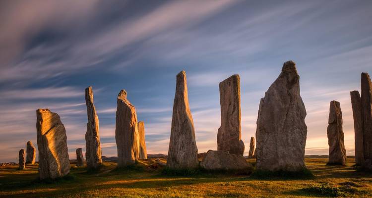 Les anciennes pierres levées de Callanish se dressent majestueusement sous un ciel vespéral nuancé sur l'île de Lewis.