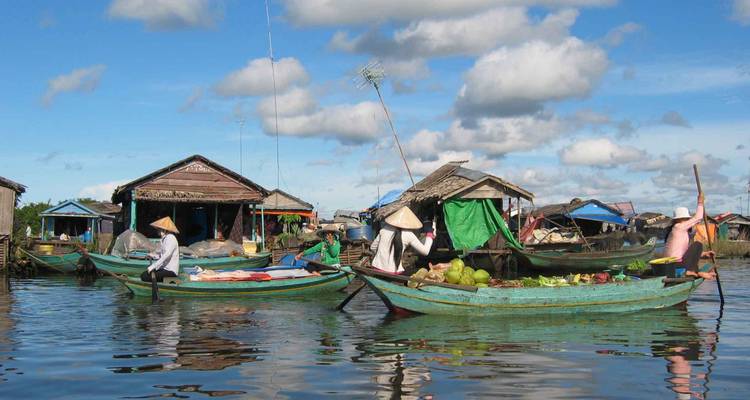 A floating market scene with sellers in boats, likely in Cambodia.