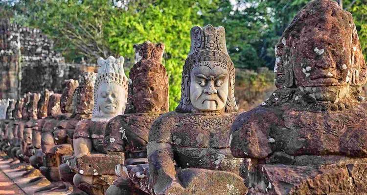 A row of stone statues, part of Angkor Thom, possibly in Cambodia.