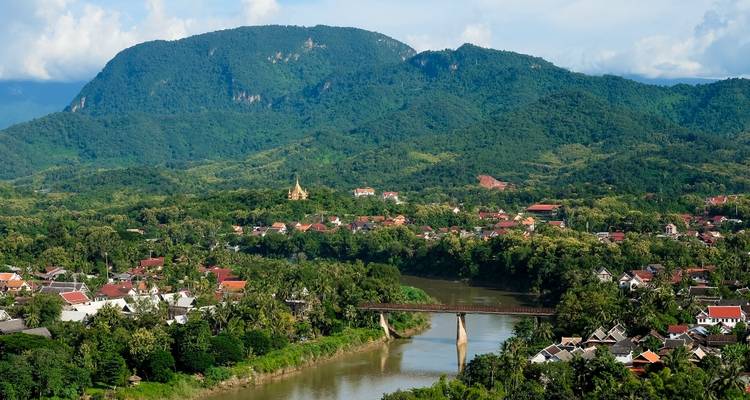Aerial view of a river flowing through a valley with mountains.