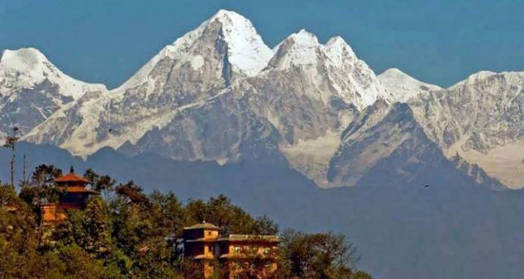 Close view of Himalayan mountains with nearby structures.