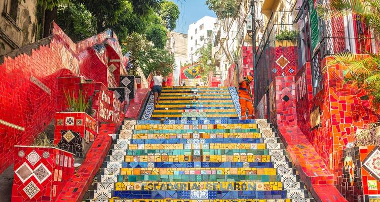Vibrant Escadaria Selarón staircase in Rio de Janeiro decorated with colorful ceramic tiles and visitors climbing the steps.