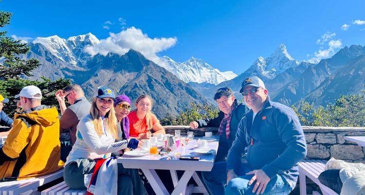 Group of people dining with a view of the mountains.
