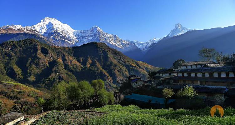Traditional Nepali village with mountains in the background.
