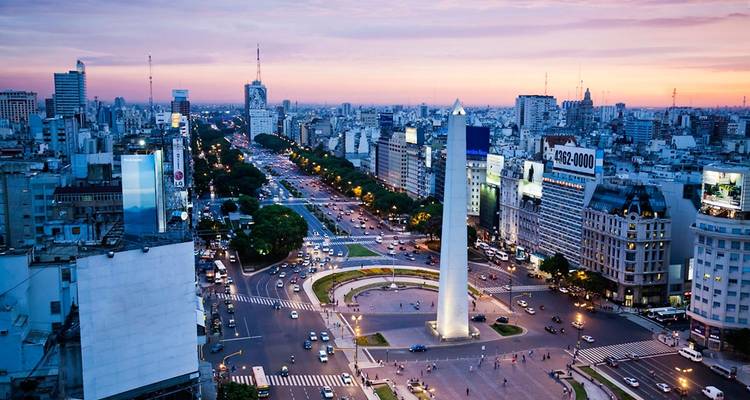 Aerial view of a bustling city with a prominent obelisk.