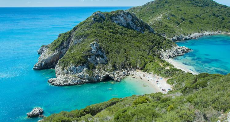 Paysage côtier pittoresque avec une baie et une végétation luxuriante.