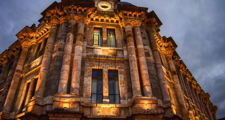 Close-up view of an ornate building facade with lighting, likely in Quito, Ecuador.