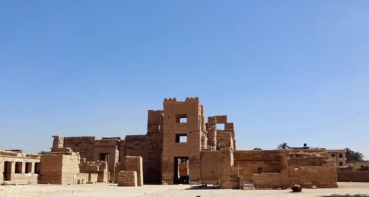 Ruins of ancient stone buildings under a clear blue sky.
