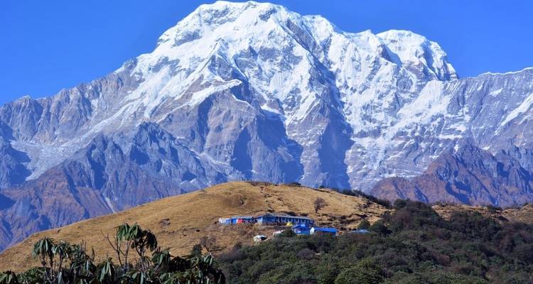 Snow-capped mountain with clear blue sky.
