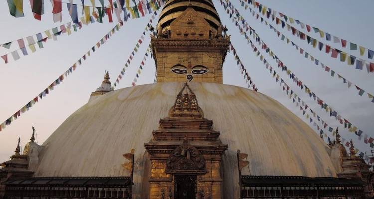 Boudhanath Stupa with prayer flags surrounding the dome.