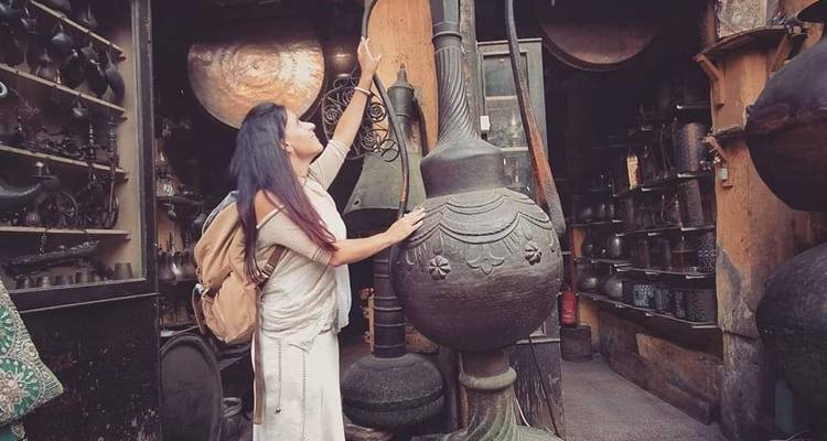 A woman exploring a market with traditional goods.
