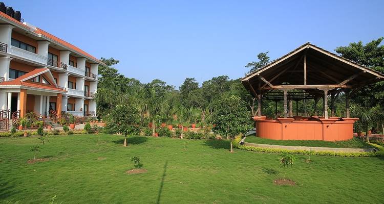 Hotel garden with building and gazebo.