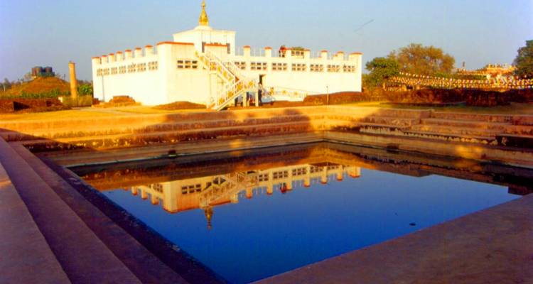 Historic building with a pool reflecting the structure in the foreground.