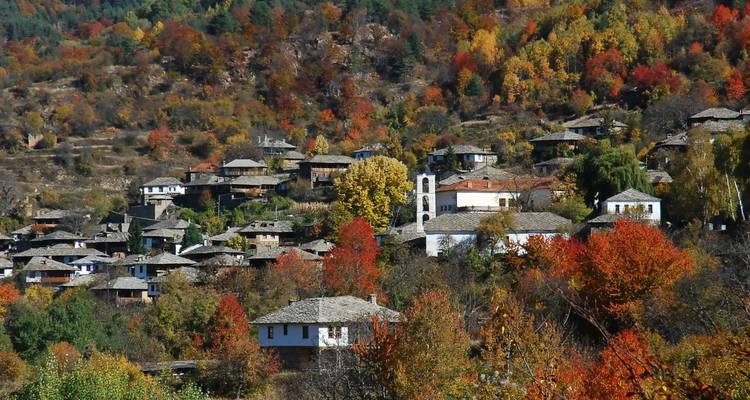 Mountain village with colorful autumn foliage.