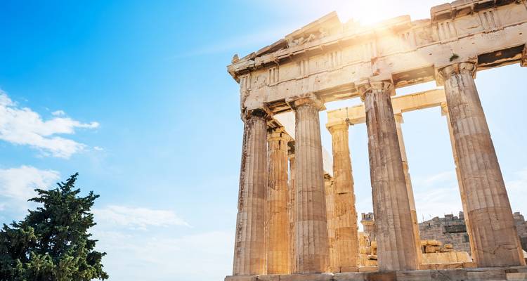 Acropolis ruins under a bright sky.