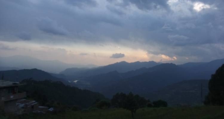 Blurry, overcast mountain landscape with low visibility.
