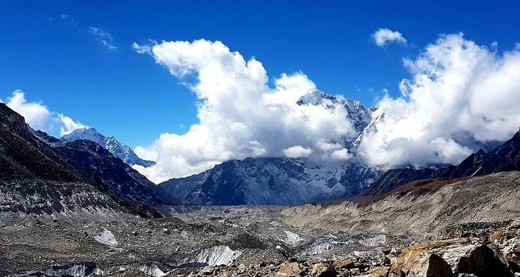 Clouds hovering over a vast mountain range.