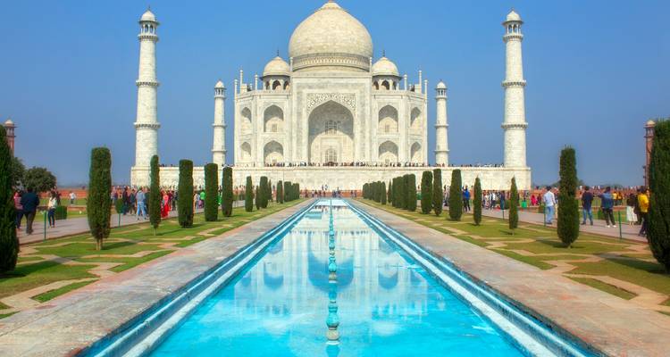 Symmetrisch zicht op het reflectiebad van de Taj Mahal met bezoekers langs de paden