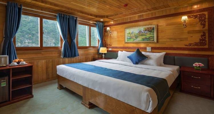 A cozy cabin room onboard a cruise ship with scenic views outside the window.
