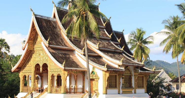 Ornate temple with detailed architecture surrounded by lush vegetation.