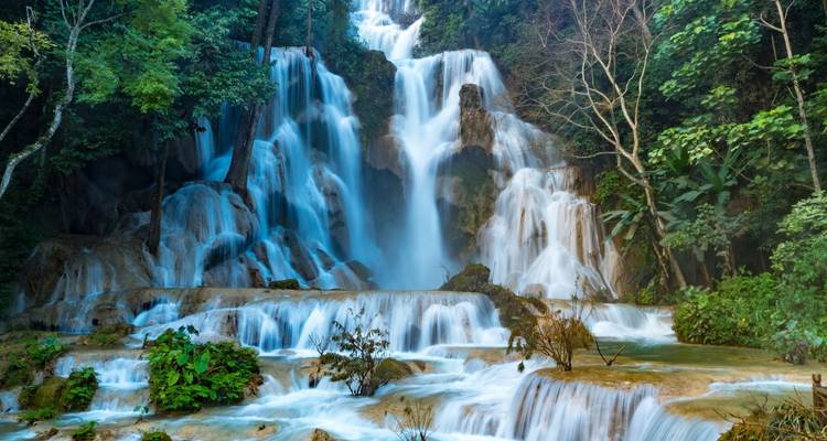 A picturesque waterfall cascading over multiple tiers into a serene pool.