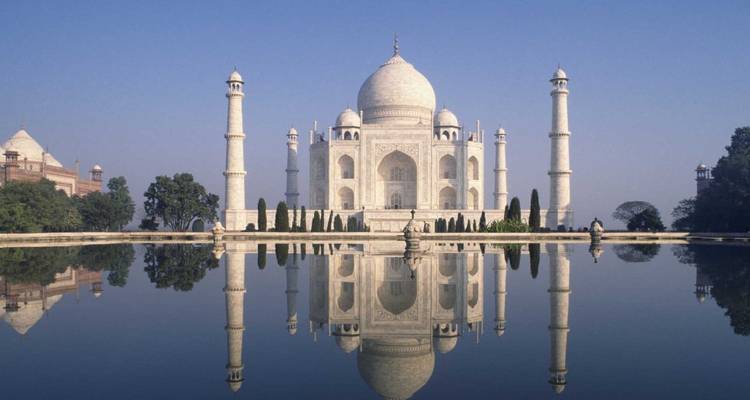 Taj Mahal reflected in a water body.