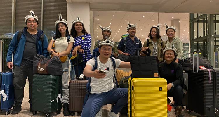 Grupo de viajeros con equipaje en un aeropuerto o terminal de transporte.