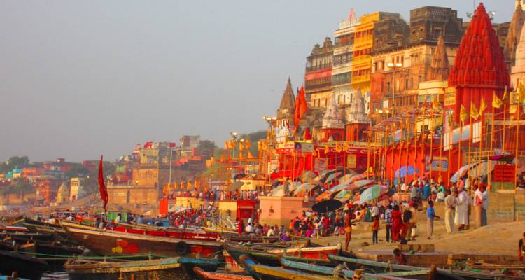 Bunte Ghats von Varanasi mit Booten auf dem Fluss während der Abenddämmerung.